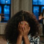 A-Girl-in-Black-and-White-Shirt-Covering-Her-Face