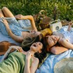 A-Group-of-Women-Lying-on-a-Picnic-Blanket-while-Having-Fun