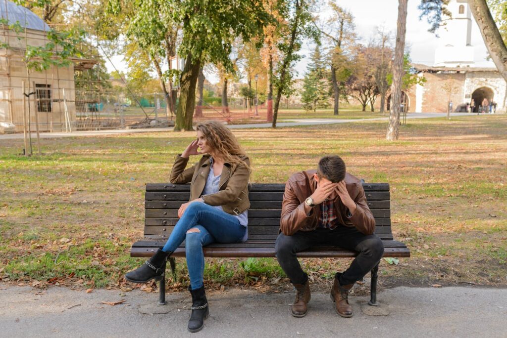 Anxiety-Woman-And-Man-Sitting-on-Brown-Wooden-Bench