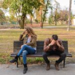 Anxiety-Woman-And-Man-Sitting-on-Brown-Wooden-Bench