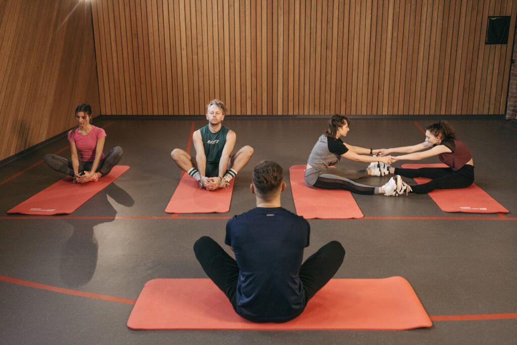 Group-of-People-Stretching-in-Yoga-Studio