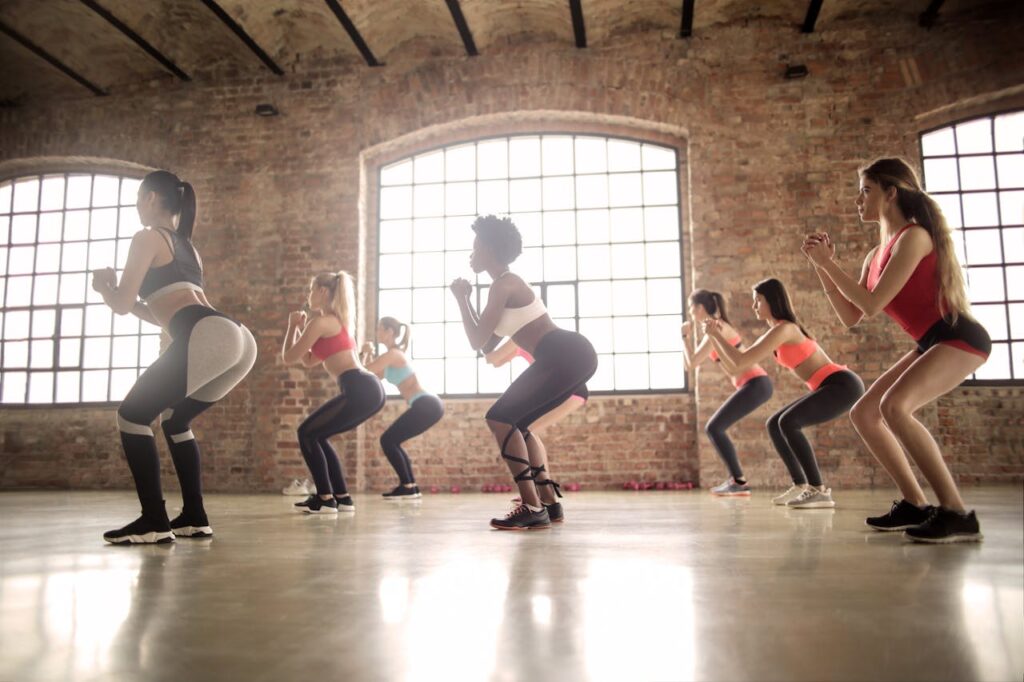 Group-of-Women-Doing-squat-Exercise-Inside-The-Building