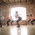 Group-of-Women-Doing-squat-Exercise-Inside-The-Building