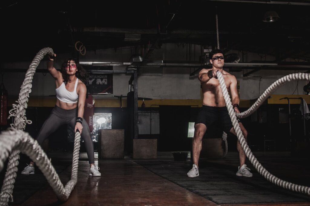 Man-And-Woman-Holding-Battle-Ropes