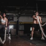 Man-And-Woman-Holding-Battle-Ropes