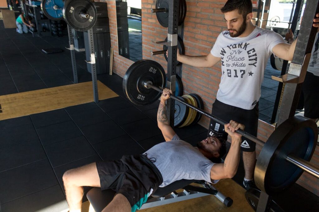Man-Lying-While-Doing-Barbell