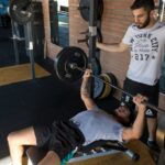 Man-Lying-While-Doing-Barbell