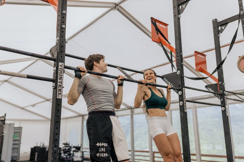 Man-and-Woman-Doing-Pull-Ups-at-the-Gym