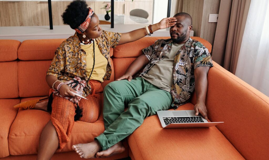 Man-and-Woman-Sitting-on-Orange-Sofa