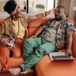 Man-and-Woman-Sitting-on-Orange-Sofa