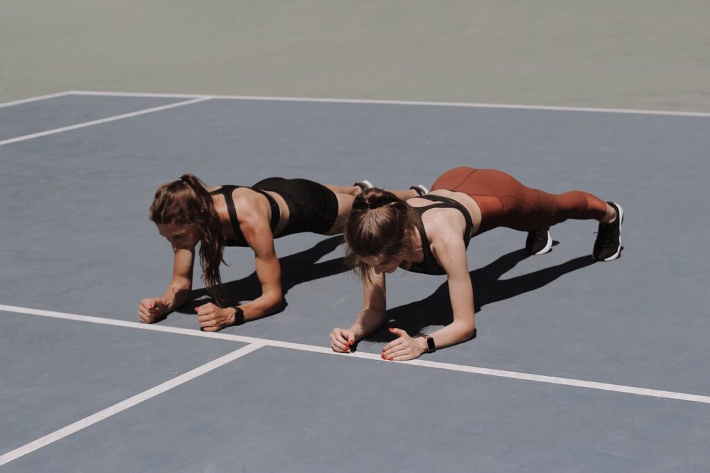 Two-Women-Doing-bear-plank-exercise-Together