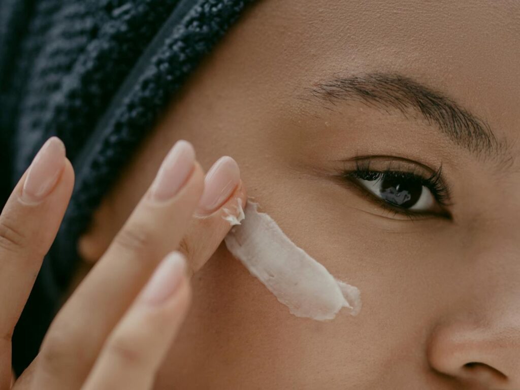 Woman-Putting-Face-Cream-on-Cheek