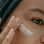 Woman-Putting-Face-Cream-on-Cheek
