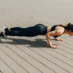 Woman-in-Black-Tank-Top-and-Black-Leggings-Doing-Yoga