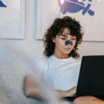 young-lady-using-netbook-on-couch-at-home
