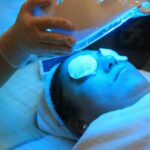 A-Beautician-Putting-an-LED-Face-Mask-on-a-Woman