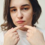 A-Woman-Popping-a-Pimple