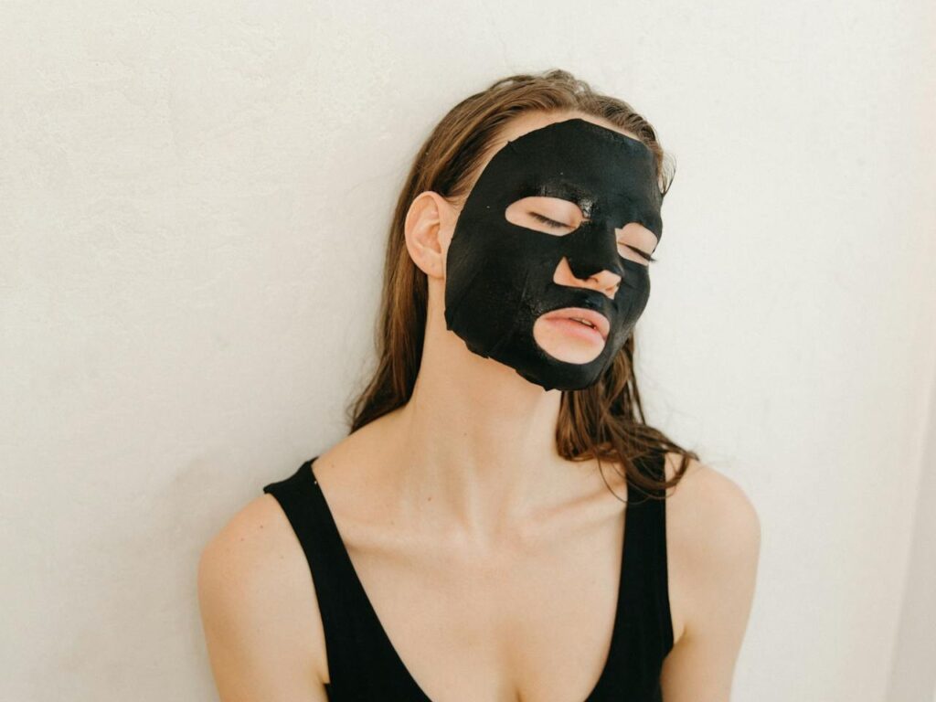 A-Woman-in-Black-Tank-Top-With-Facial-Mask