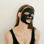 A-Woman-in-Black-Tank-Top-With-Facial-Mask