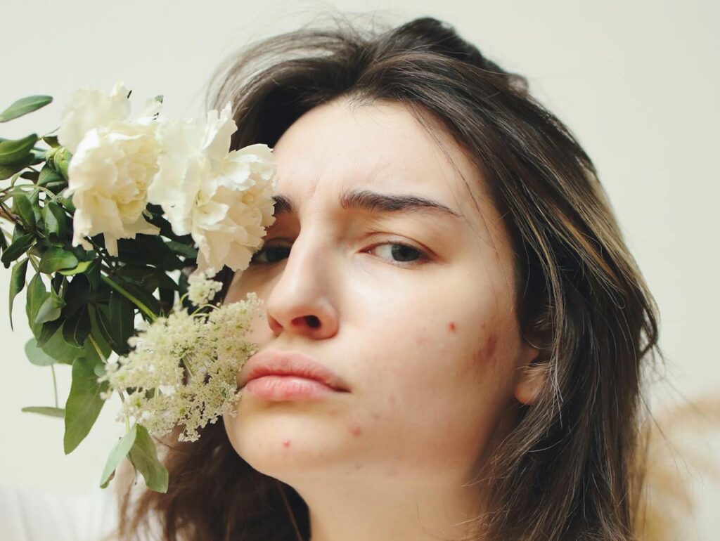 Close-up-Photo-of-Woman-beside-a-White-Flower