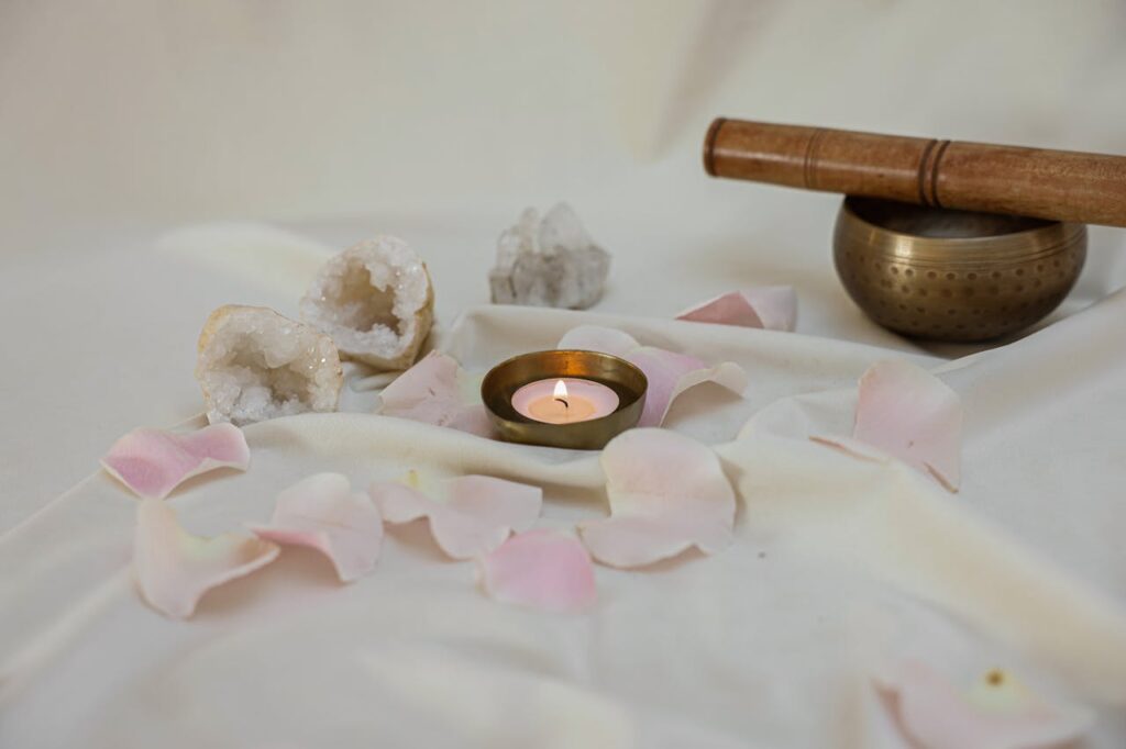 Lighted-Candle-Beside-a-Tibetan-Singing-Bowl-on-White-Linen