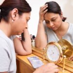 Tired-Woman-Sitting-by-Mirror