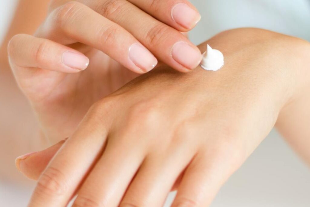 Woman-Applying-Lotion-on-Hand