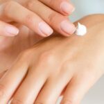 Woman-Applying-Lotion-on-Hand