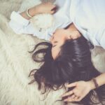 Woman-Lying-on-Beige-Faux-fur-Mat