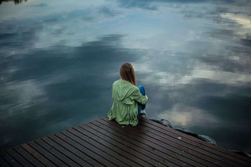 Woman-Sitting-on-Wooden-Planks