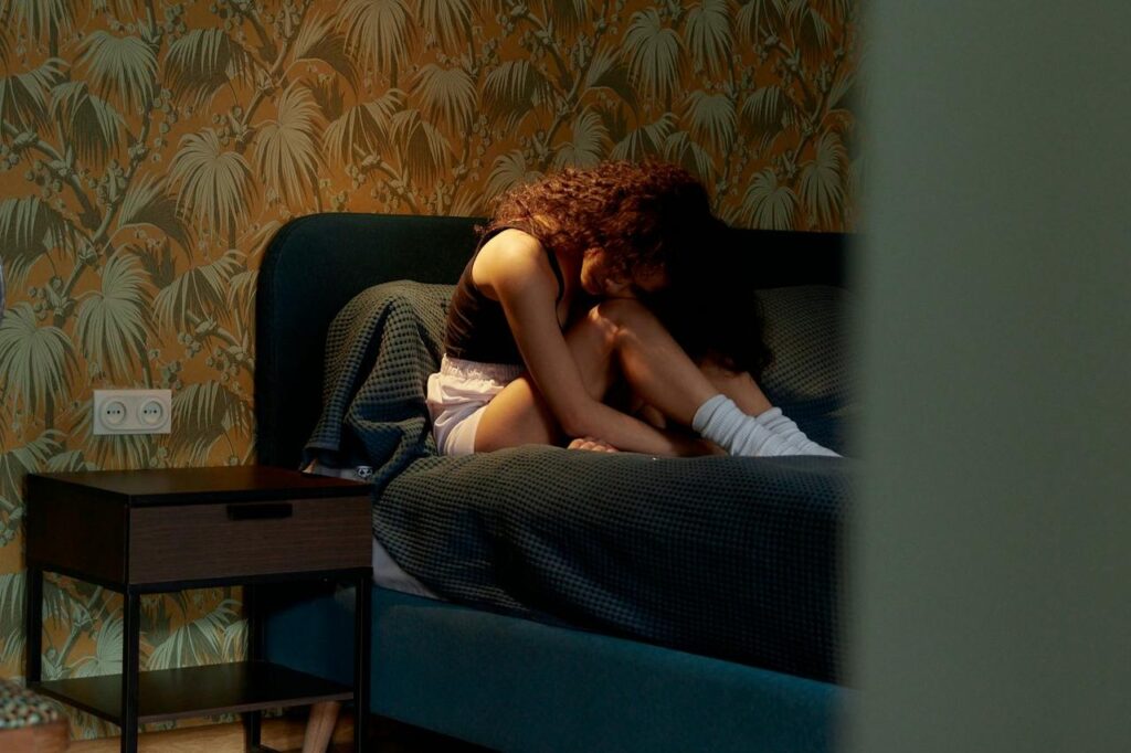 Woman-Sitting-on-a-Bed
