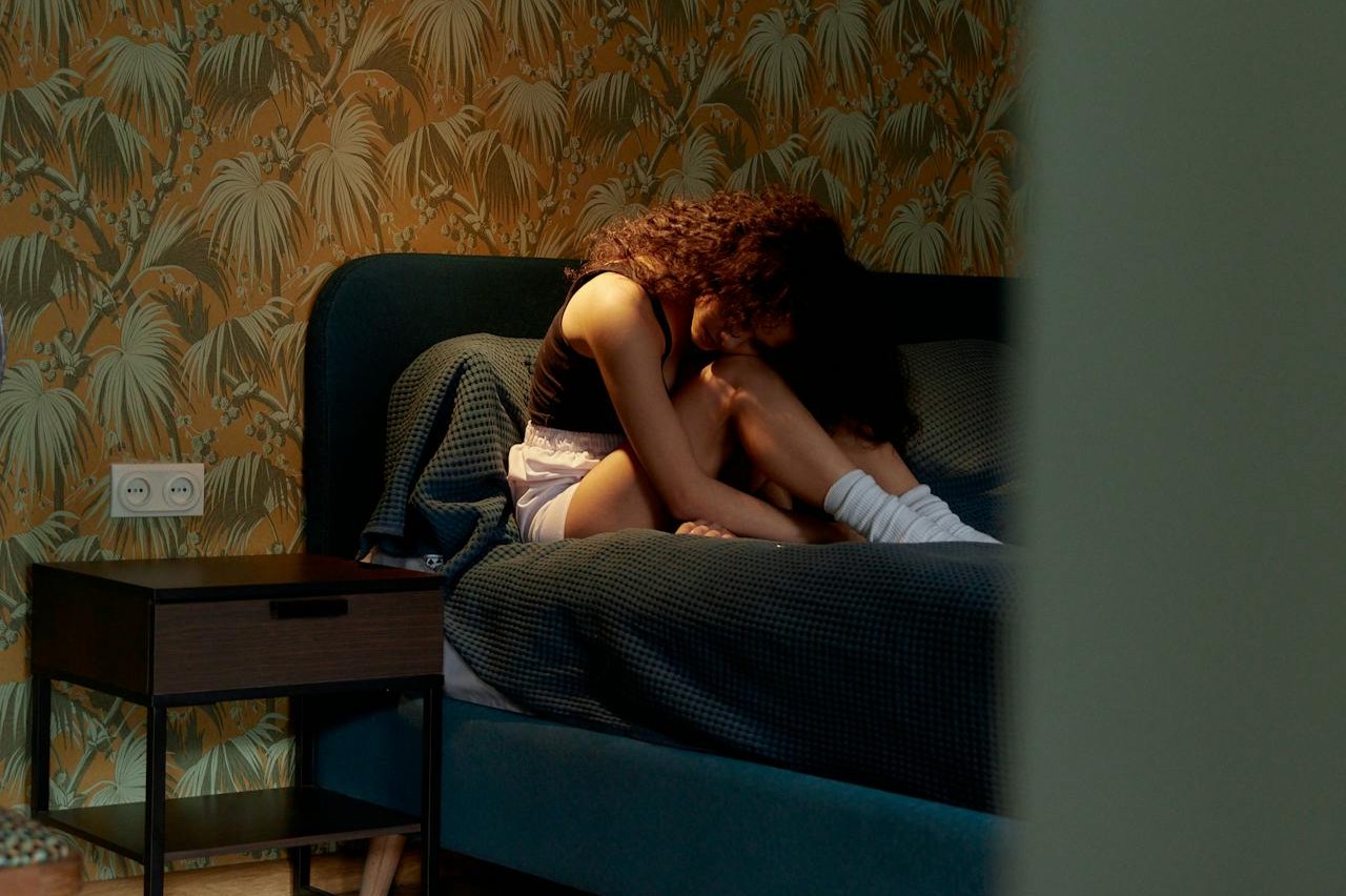 Woman-Sitting-on-a-Bed