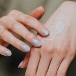 woman-applying-cream-on-hands